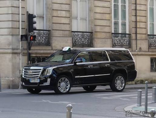 Black Cadillac Escalade ESV on a quiet city street